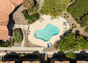 Thumbnail 63 of 87 - an aerial view of a swimming pool in a backyard with trees