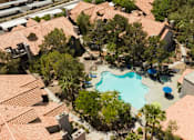 Thumbnail 52 of 87 - an aerial view of a swimming pool surrounded by houses