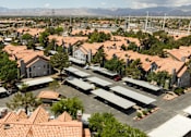 Thumbnail 65 of 87 - an aerial view of a suburban neighborhood with houses and cars