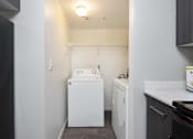 Thumbnail 13 of 87 - a small laundry room with a washer and dryer and a white washer