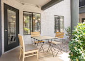 Thumbnail 20 of 87 - a patio with a table and chairs outside of a house