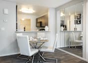 Thumbnail 6 of 87 - a dining room with a table and chairs and a kitchen