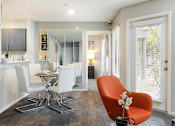 Thumbnail 5 of 87 - a living room and dining room with a table and chairs