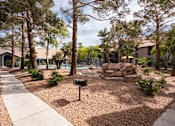 Thumbnail 76 of 87 - a backyard with a pool and trees and a sidewalk