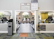 Thumbnail 48 of 87 - a gym with cardio equipment and a sign on the wall
