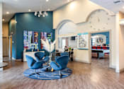 Thumbnail 85 of 87 - a lobby with blue chairs and a large clock on the wall