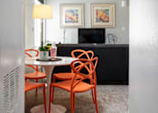 Thumbnail 32 of 87 - a dining room with a table and chairs and a living room