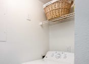 Thumbnail 31 of 87 - a white washer and dryer in a laundry room with a basket on top