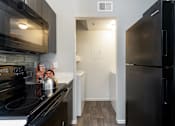 Thumbnail 30 of 87 - a kitchen with stainless steel appliances and a black refrigerator