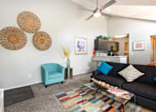 Thumbnail 24 of 87 - a living room with a couch and a chair and a ceiling fan