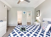 Thumbnail 37 of 87 - a blue and white bedroom with a bed and a ceiling fan