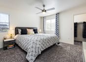 Thumbnail 9 of 43 - a bedroom with a bed and a ceiling fan