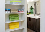 Thumbnail 18 of 43 - a bathroom with shelves and a sink and a mirror