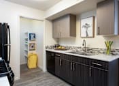 Thumbnail 22 of 43 - a kitchen with wooden cabinets and a white counter top