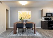 Thumbnail 5 of 43 - a dining room with a table and chairs and a kitchen