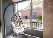 Thumbnail 24 of 43 - a hanging chair in front of a window