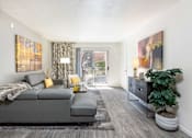 Thumbnail 3 of 43 - a living room with a gray couch and a tv