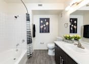 Thumbnail 12 of 43 - a bathroom with a tub and a sink and a toilet
