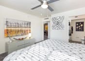 Thumbnail 11 of 43 - a bedroom with a bed and a ceiling fan
