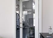 Thumbnail 32 of 43 - a glass door with a fitness center sign on it