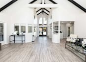 Thumbnail 39 of 43 - a living room with white walls and wood floors