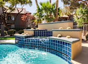 Thumbnail 29 of 43 - a swimming pool with a blue tiled fountain in a backyard