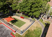 Thumbnail 49 of 54 - an aerial view of a park with a basketball court and a red court