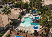 Thumbnail 44 of 54 - an aerial view of a resort style swimming pool with umbrellas