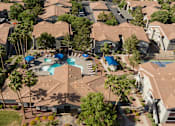 Thumbnail 43 of 54 - an aerial view of a neighborhood with houses and a swimming pool