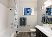 Thumbnail 25 of 54 - a bathroom with a shower and a toilet and a sink