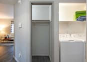 Thumbnail 20 of 54 - a laundry room with a washer and dryer and a closet with a sink