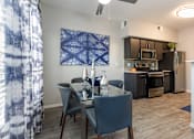 Thumbnail 6 of 54 - a dining room with a table and chairs and a kitchen