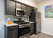 Thumbnail 9 of 54 - a kitchen with stainless steel appliances and a refrigerator