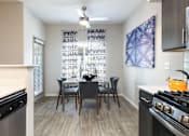 Thumbnail 5 of 54 - a kitchen and dining room area with a table and chairs and a stove