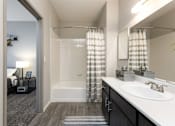 Thumbnail 17 of 54 - a bathroom with a shower and a sink and a mirror