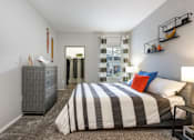 Thumbnail 14 of 54 - a bedroom with a bed and a dresser and a window