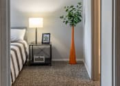 Thumbnail 12 of 54 - a bedroom with a bed and a vase with a plant