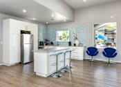 Thumbnail 34 of 54 - a kitchen with an island and blue chairs