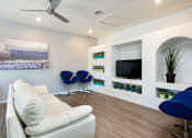 Thumbnail 33 of 54 - a living room with a white couch and a television