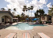 Thumbnail 39 of 54 - a large swimming pool with palm trees in the background
