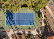 Thumbnail 41 of 47 - an aerial view of a tennis court with green grass and trees