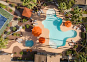 Thumbnail 35 of 47 - an overhead view of a swimming pool at a resort with umbrellas