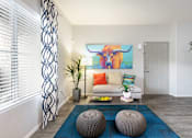 Thumbnail 2 of 47 - a living room with a couch and a painting of a bull