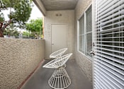 Thumbnail 26 of 47 - a patio with two chairs and a table in front of a door