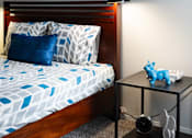 Thumbnail 25 of 47 - a small bedroom with a bed and a night stand