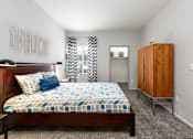 Thumbnail 20 of 47 - a bedroom with a bed and a dresser and a window