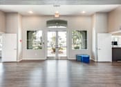 Thumbnail 29 of 47 - an empty living room with white doors and a hard wood floor