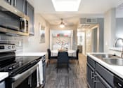 Thumbnail 6 of 36 - a kitchen and dining room with a table and chairs