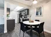 Thumbnail 3 of 36 - an open kitchen and dining area with a table and chairs