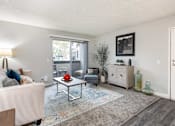 Thumbnail 1 of 36 - a living room with a couch and a table